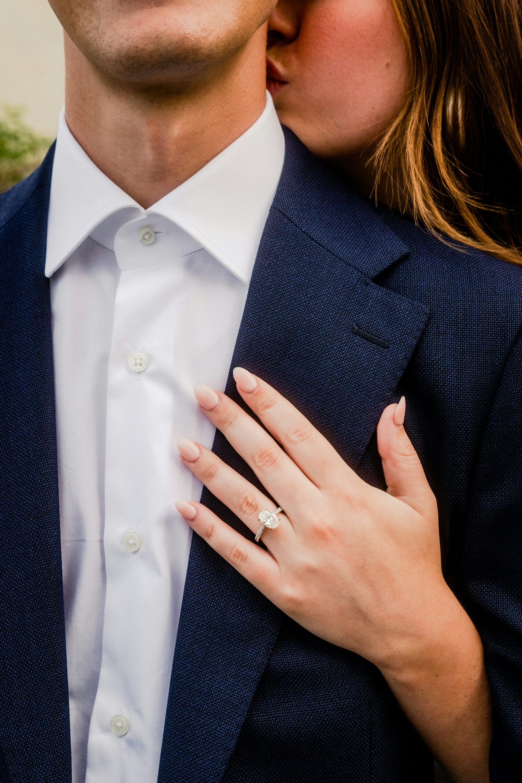 Oval diamond engagement ring by Jay Gems worn by bride